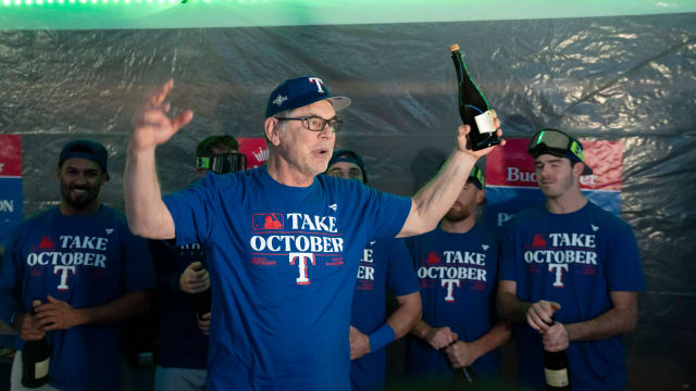 Texas Rangers manager Bruce Bochy addresses his team in the clubhouse after clinching a playoff berth Saturday night at T-Mobile Park in Seattle.